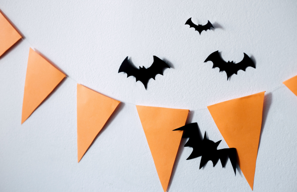 paper cut out bats and orange colored decorations